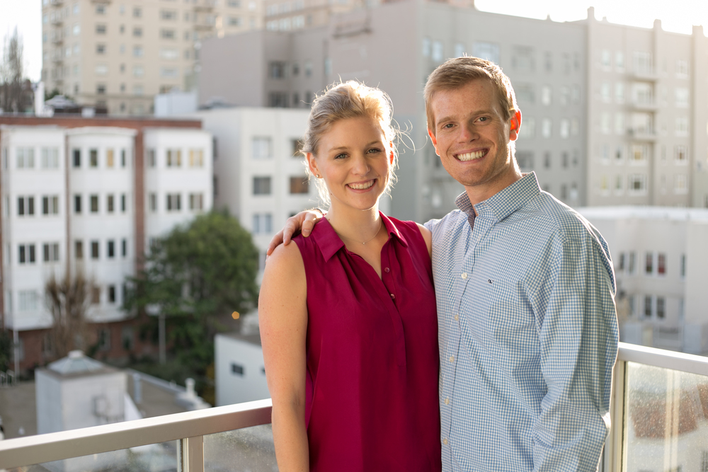 couple smiling at camera on balcony